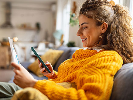 Woman using phone in living room