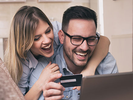 Young couple paying with credit card online